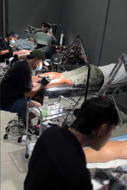 Tattoo artist working on a client